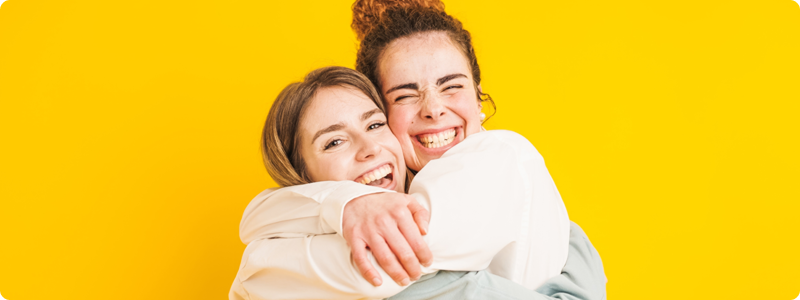Two people hugging and smiling