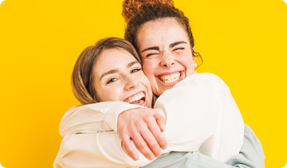 Two people hugging and smiling