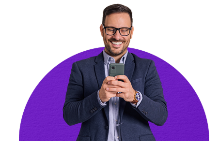 Smiling man holding smartphone as he shops business gift cards online