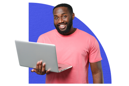 Smiling man holding laptop as he browses gift cards online
